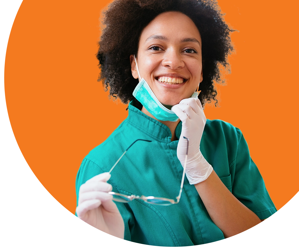 A dental assistant inspects the mouth of a patient