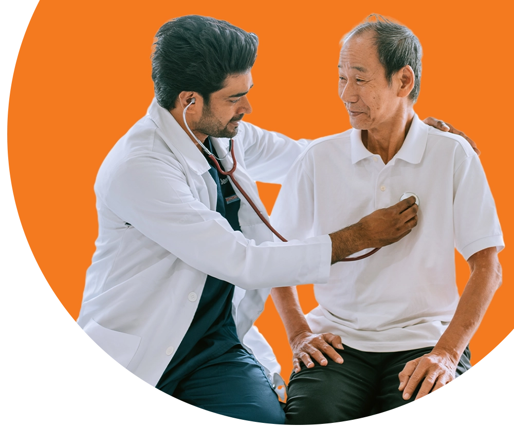 A doctor using a stethoscope on an elderly patient.