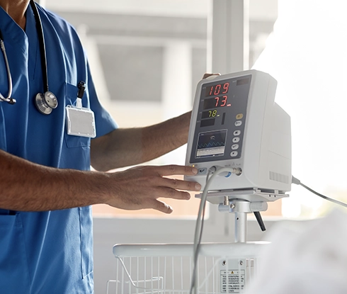 A doctor using a stethoscope on an elderly patient.