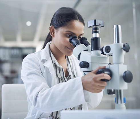 A medical professional looks at the camera and smiles.